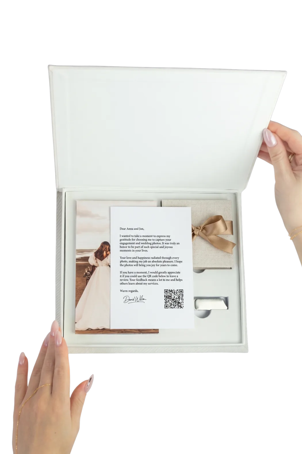 The Lens + Linen Full Set, open: Flip notepad, personalized note, Fold brag book tied with a ribbon, and Archive USB drive